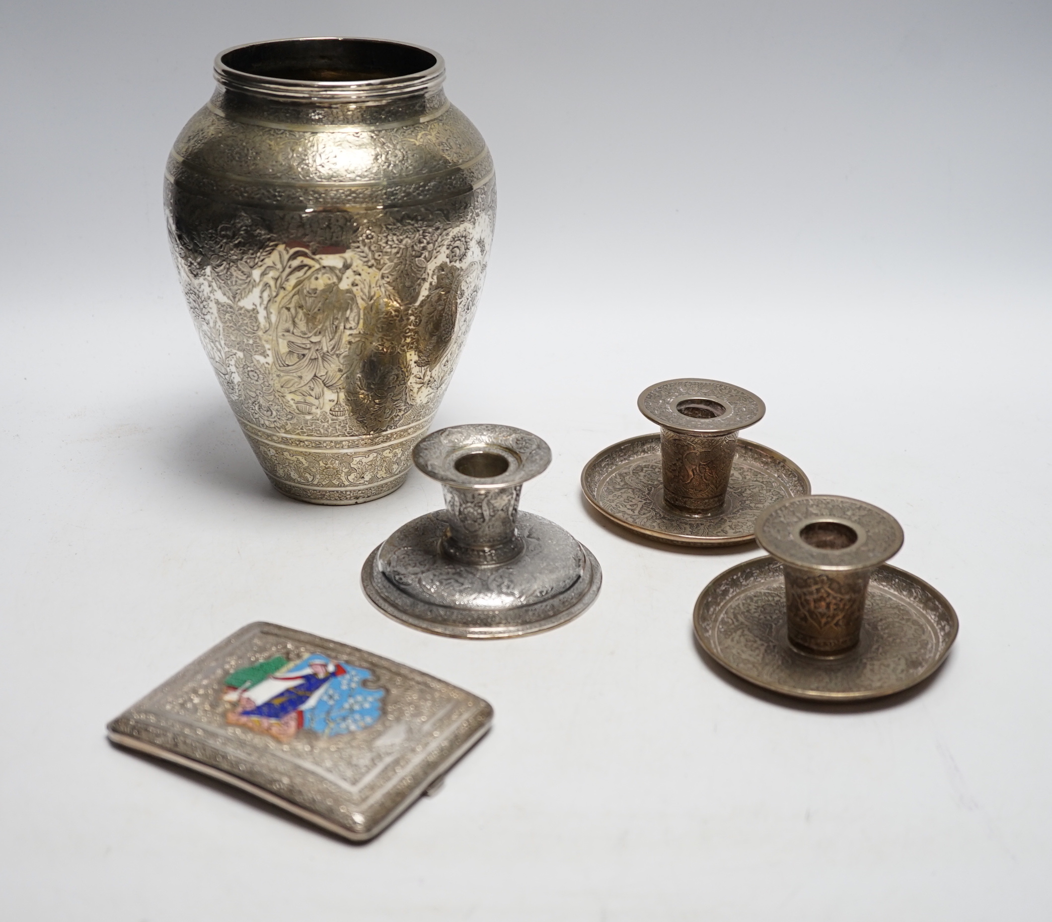 Three Persian white metal dwarf candlesticks including a pair, base 88mm, a similar white metal and enamelled cigarette case and a Persian metal vase.